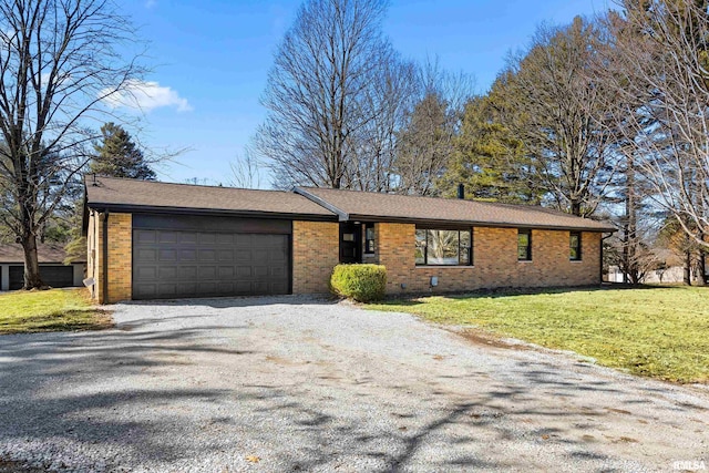 single story home featuring a garage, a front lawn, and brick siding