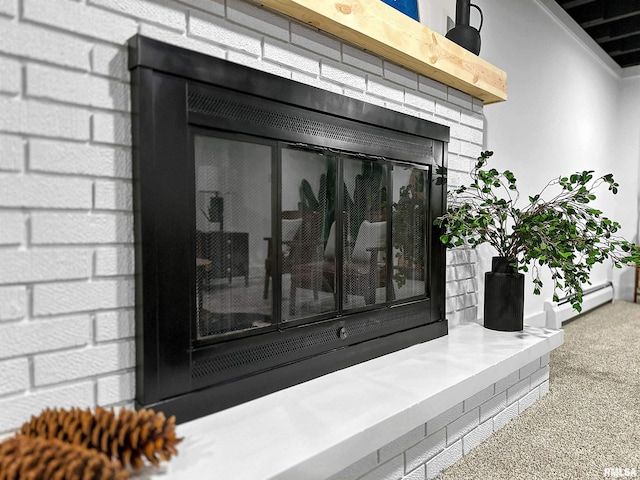 interior details featuring a baseboard radiator and a brick fireplace