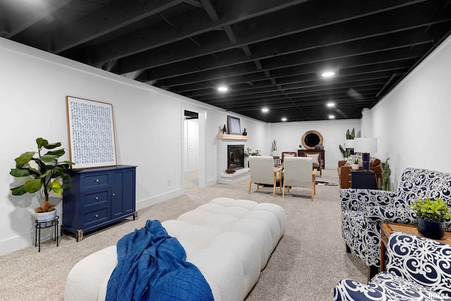 carpeted living room featuring a fireplace and baseboards