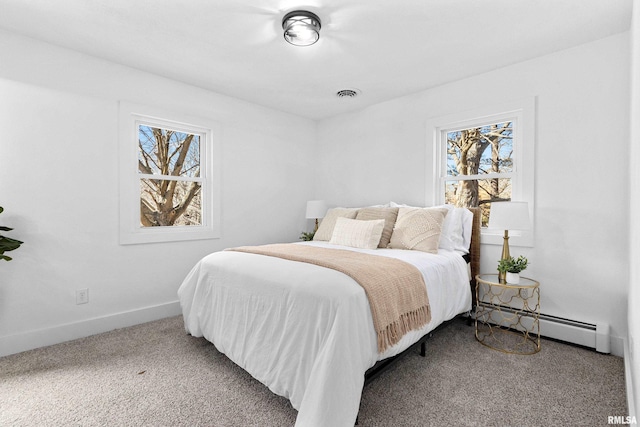 bedroom featuring a baseboard radiator, multiple windows, visible vents, and carpet flooring