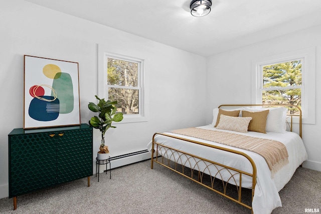 carpeted bedroom featuring a baseboard heating unit