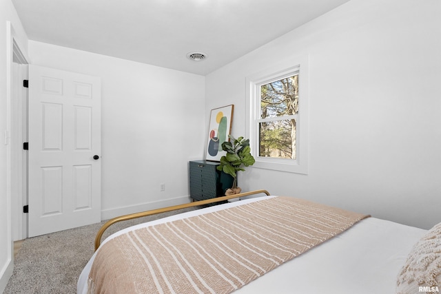 bedroom featuring carpet flooring, visible vents, and baseboards