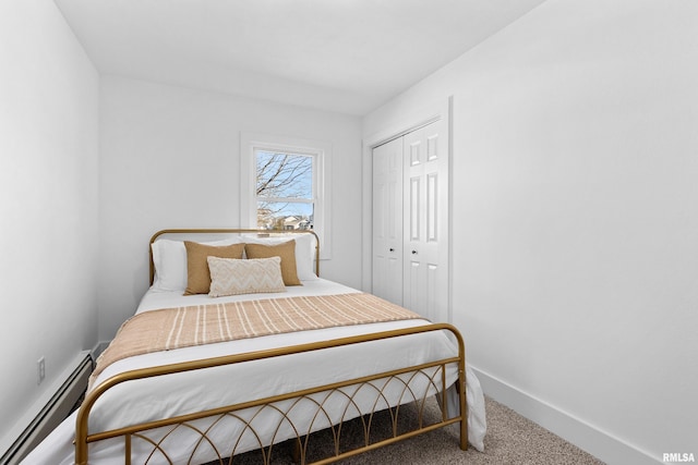 carpeted bedroom featuring baseboards, a baseboard heating unit, and a closet