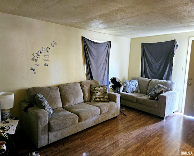 living room with a textured ceiling and wood finished floors