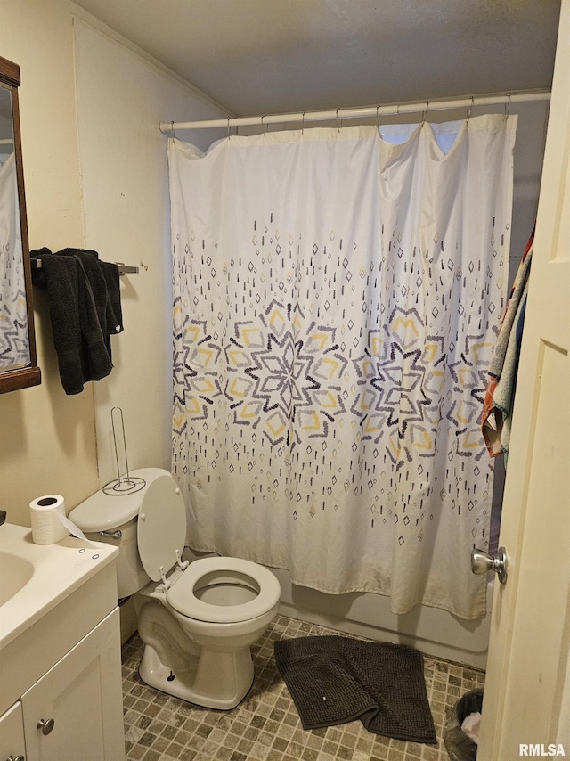 full bath with shower / bath combo with shower curtain, tile patterned flooring, vanity, and toilet