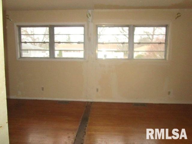 spare room featuring wood finished floors