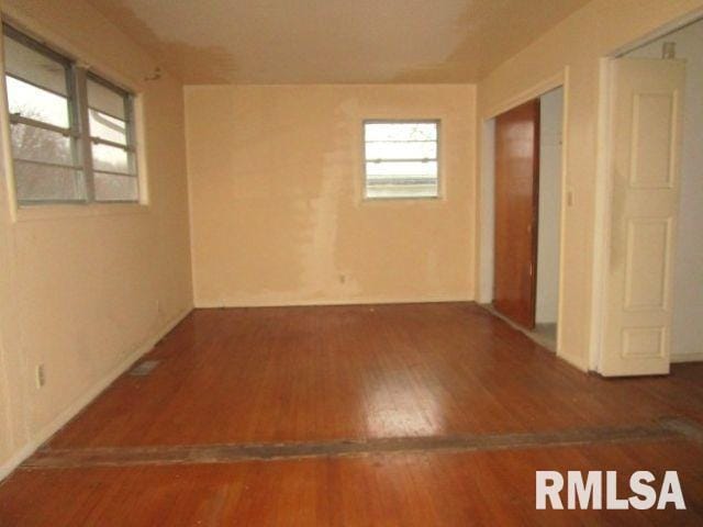 spare room with wood finished floors