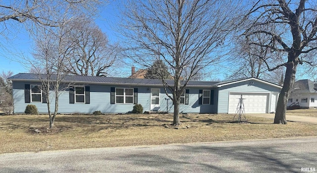 single story home featuring a garage, metal roof, driveway, and a chimney