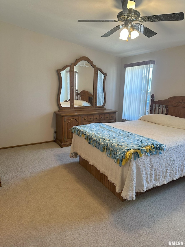 carpeted bedroom featuring ceiling fan and baseboards