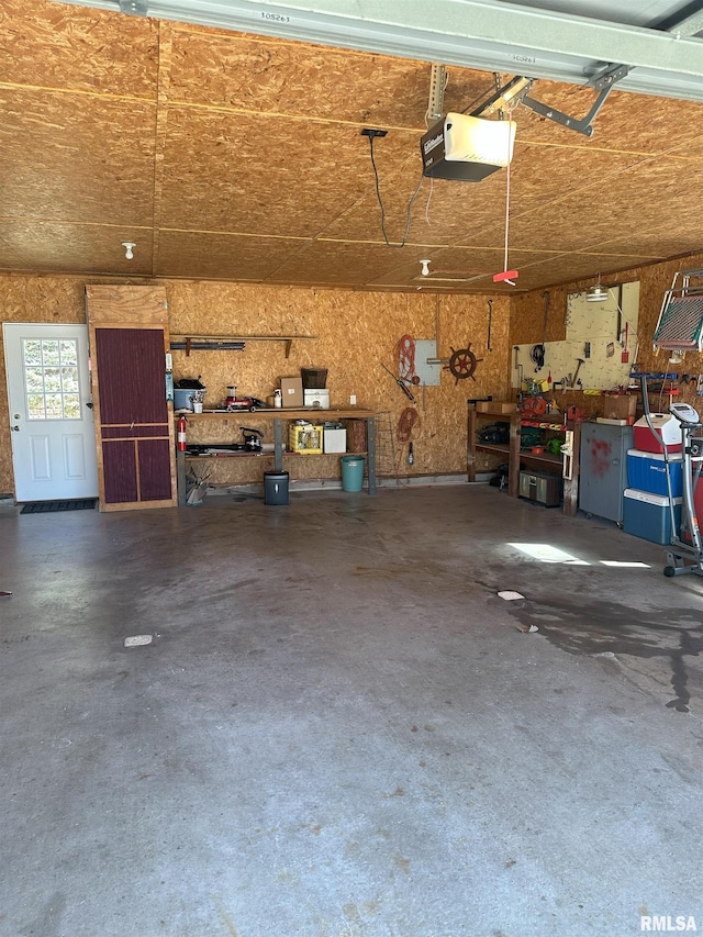 garage featuring a garage door opener and a workshop area