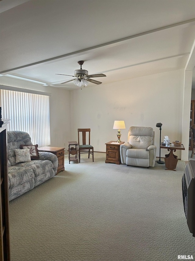 living area featuring a ceiling fan and carpet flooring