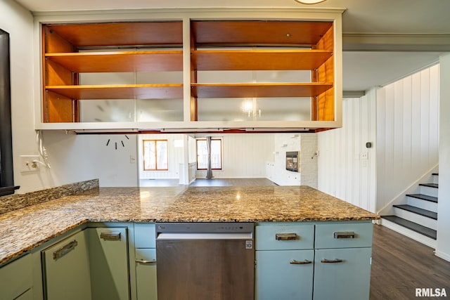 kitchen featuring open shelves, dark wood finished floors, green cabinets, and a fireplace