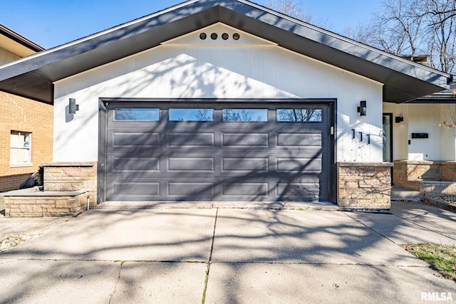 garage featuring concrete driveway