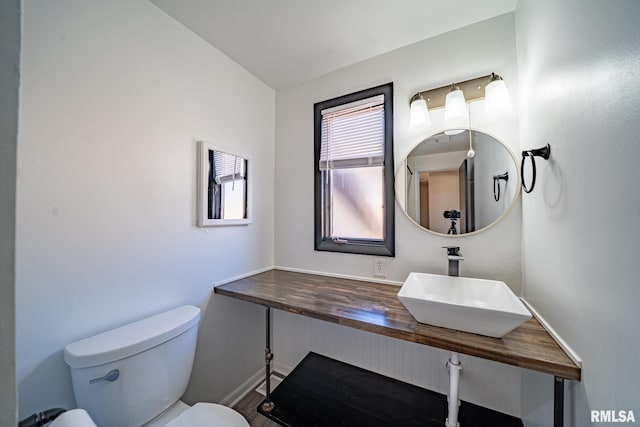 half bath featuring a sink and toilet