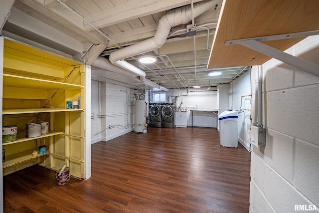 basement with gas water heater, washer and dryer, and wood finished floors