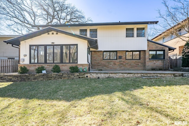 view of front of property with stone siding, a front yard, and fence