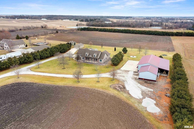 birds eye view of property with a rural view