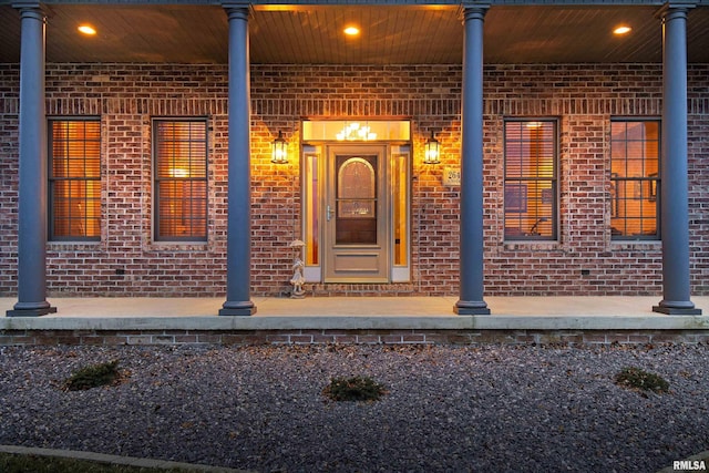 view of exterior entry with brick siding