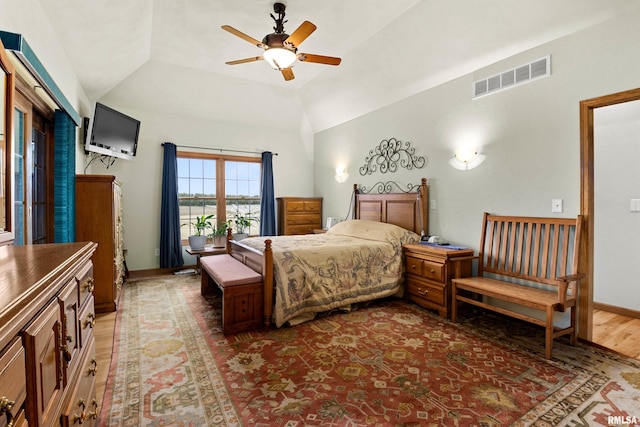 bedroom featuring baseboards, visible vents, lofted ceiling, ceiling fan, and wood finished floors