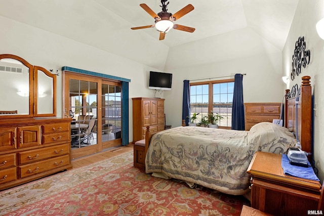 bedroom with access to exterior, visible vents, light wood-style flooring, a ceiling fan, and vaulted ceiling