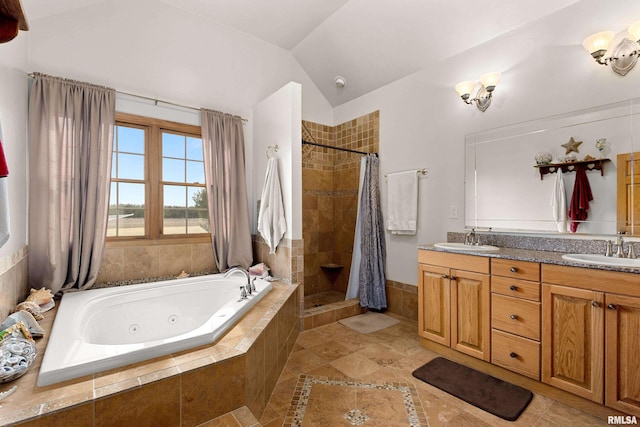 full bathroom with lofted ceiling, a stall shower, a tub with jets, and a sink