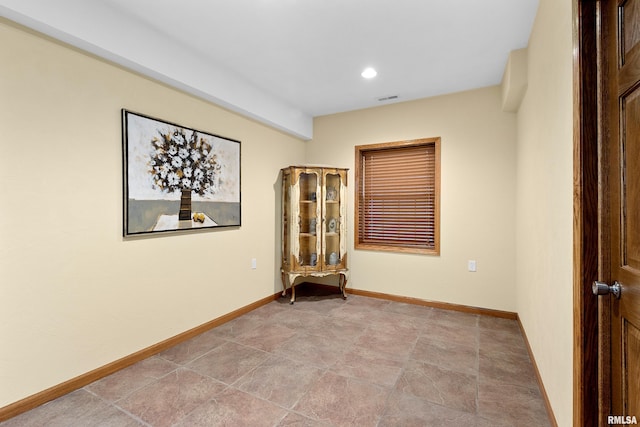 spare room featuring recessed lighting, visible vents, and baseboards