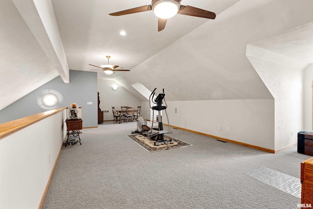 workout room with vaulted ceiling, carpet floors, a ceiling fan, and baseboards