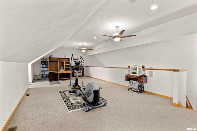 exercise room featuring carpet floors, visible vents, vaulted ceiling, and baseboards