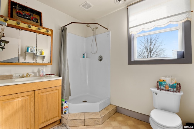 bathroom with a stall shower, visible vents, vanity, and toilet