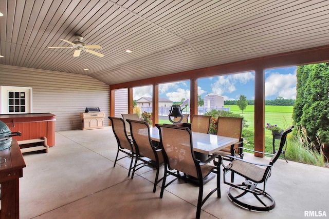 sunroom / solarium featuring vaulted ceiling and a ceiling fan