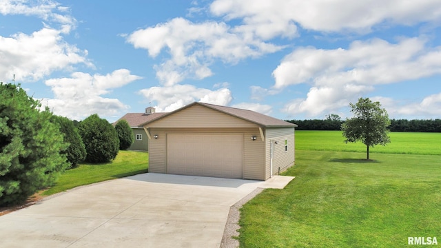 view of front of property with a detached garage and a front lawn