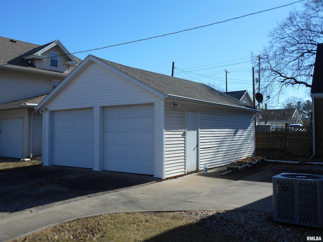 detached garage featuring central AC and fence