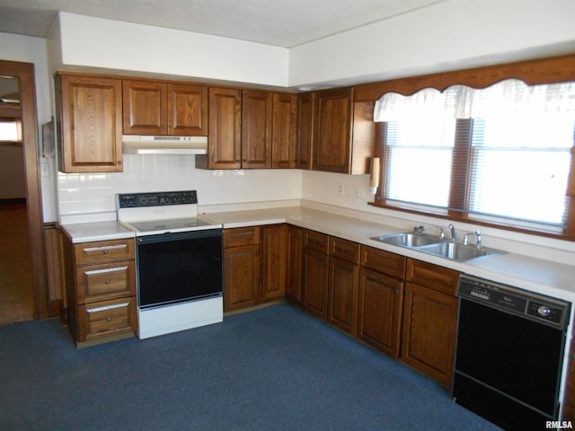 kitchen featuring black dishwasher, white range with electric cooktop, light countertops, under cabinet range hood, and a sink