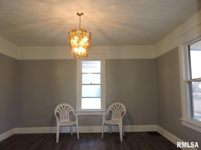 unfurnished room featuring dark wood-type flooring, a wealth of natural light, and baseboards