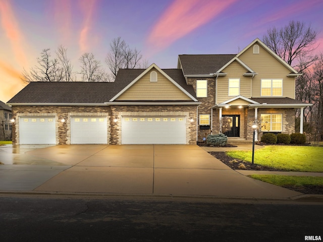 view of front of property featuring an attached garage, a front lawn, concrete driveway, and brick siding