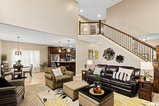 living area with stairs, a high ceiling, a chandelier, and recessed lighting