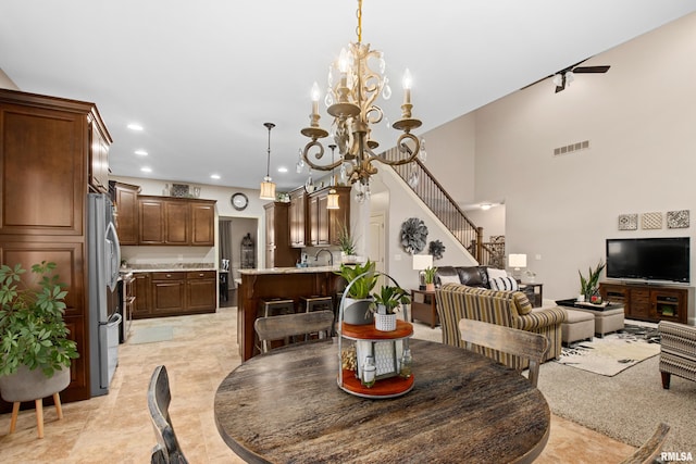 dining area with recessed lighting, visible vents, a high ceiling, an inviting chandelier, and stairs