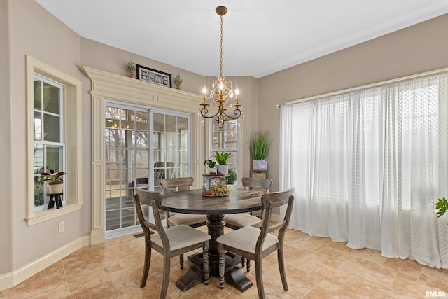 dining space with a chandelier, a wealth of natural light, and baseboards