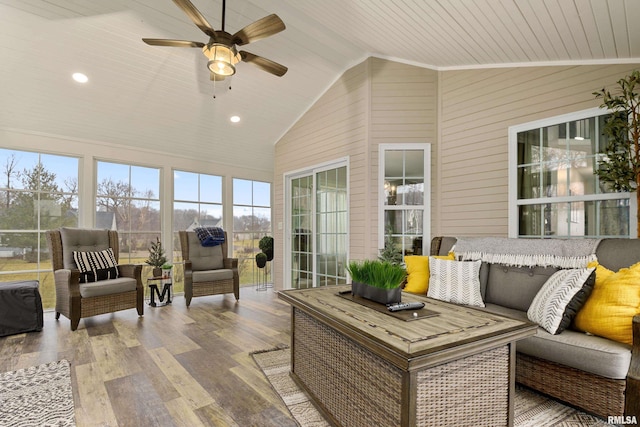 sunroom / solarium with lofted ceiling, wooden ceiling, and ceiling fan