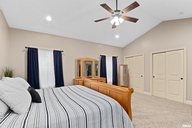 bedroom with carpet floors, multiple closets, lofted ceiling, recessed lighting, and ceiling fan