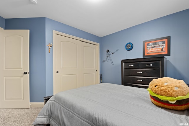 bedroom with carpet floors, a closet, and baseboards