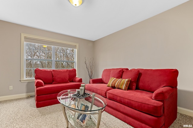 carpeted living area featuring baseboards