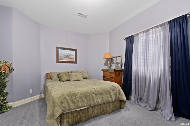 carpeted bedroom with visible vents and baseboards