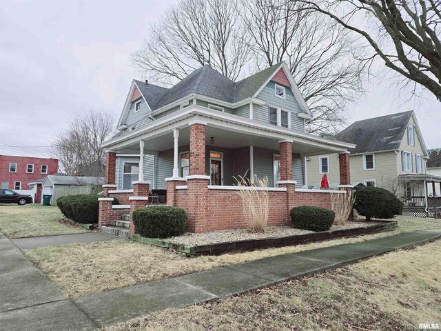 view of front of property featuring covered porch and brick siding