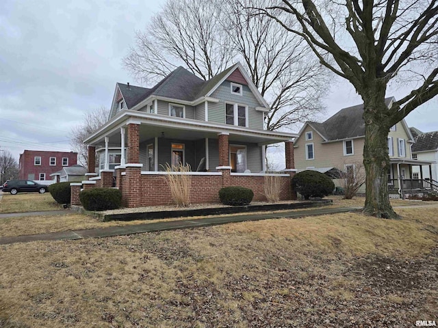 view of front of house featuring covered porch and brick siding