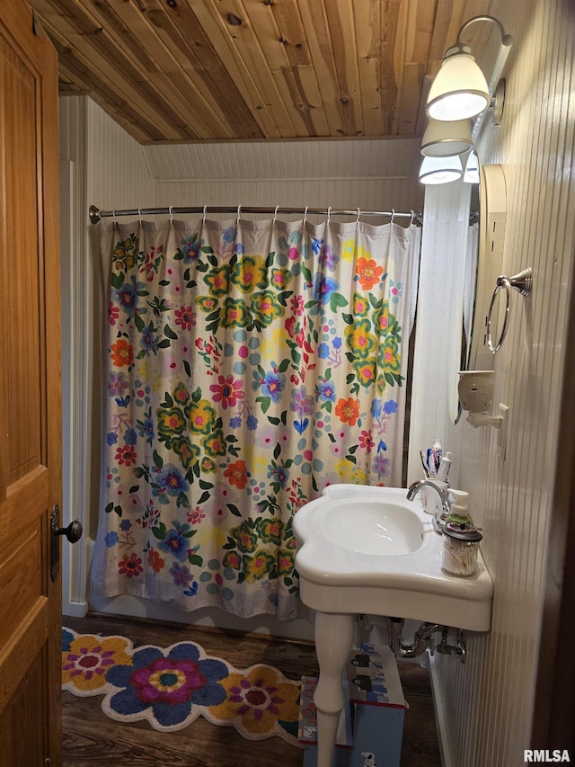 bathroom with wooden ceiling and shower / bath combination with curtain