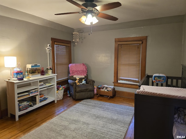 bedroom with ceiling fan and wood finished floors