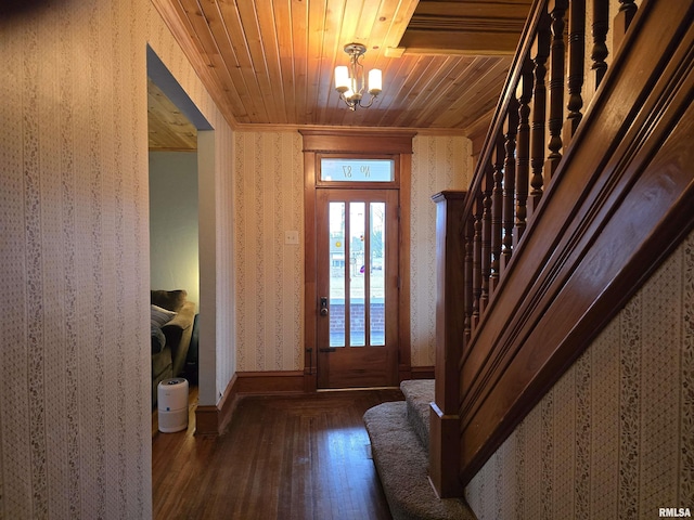 foyer entrance featuring a notable chandelier, wood ceiling, stairway, wood-type flooring, and wallpapered walls