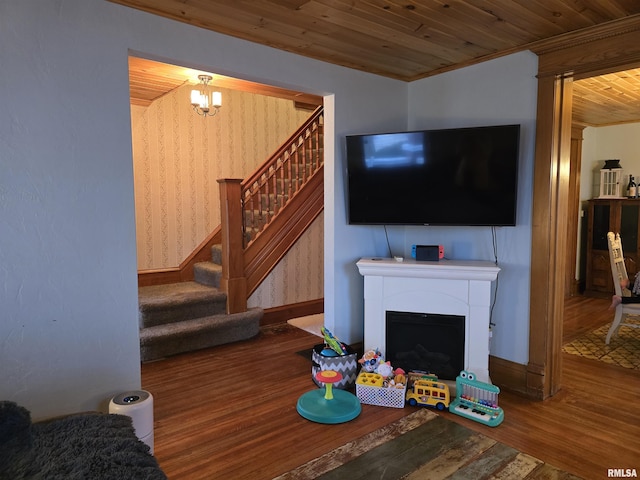 living room with wooden ceiling, a fireplace, wood finished floors, stairs, and ornamental molding