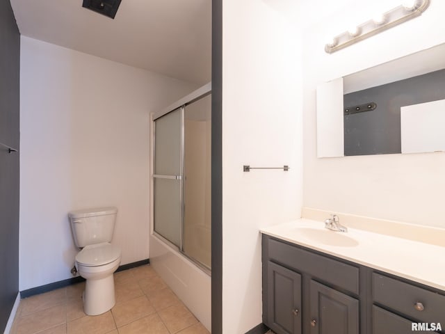 full bathroom with toilet, enclosed tub / shower combo, tile patterned flooring, baseboards, and vanity